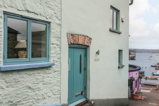 1 The Old Brewhouse, Dittisham, with boats on the water behind